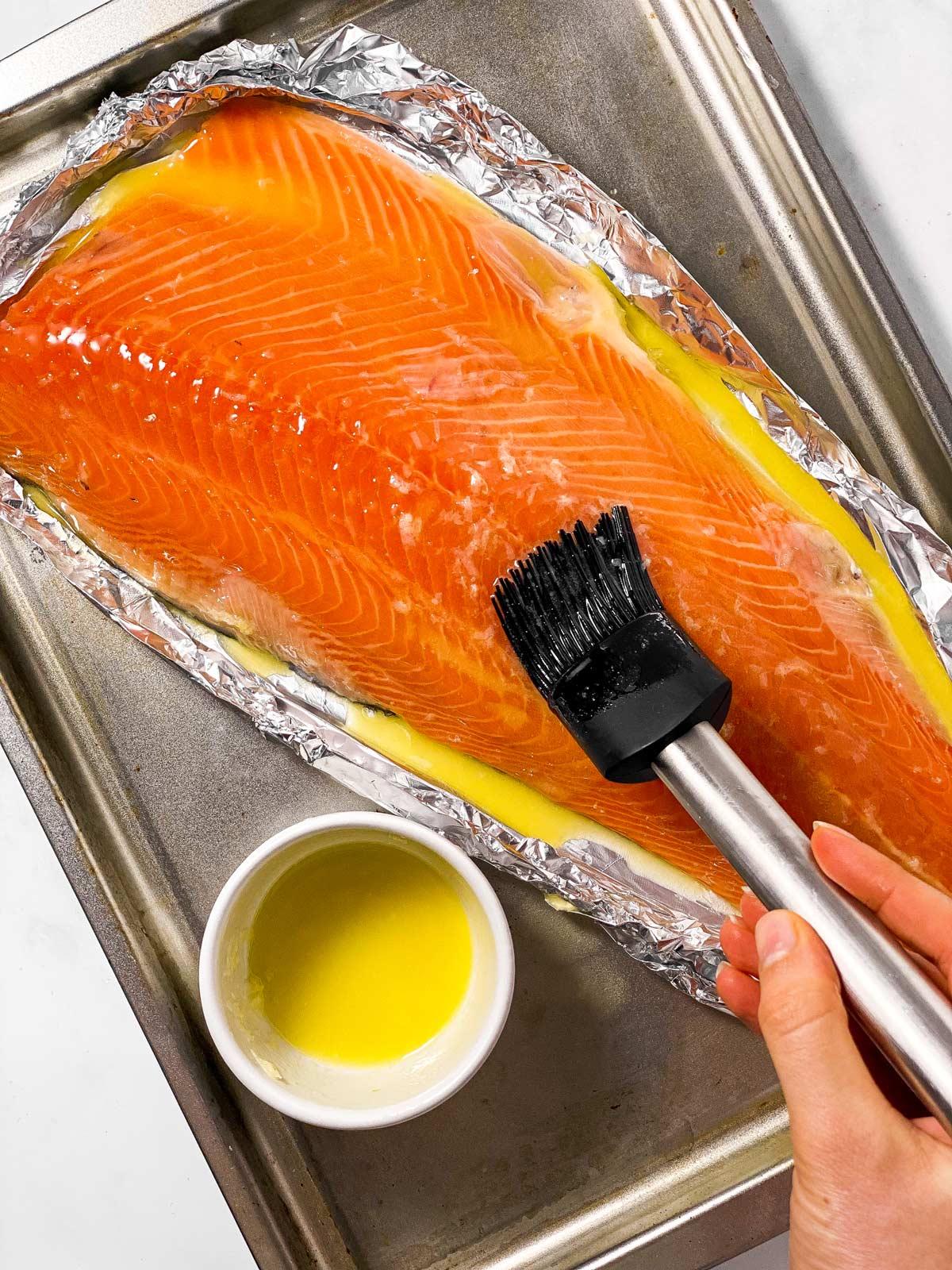 step-by-step images of brushing garlic butter and seasoning salmon fillet