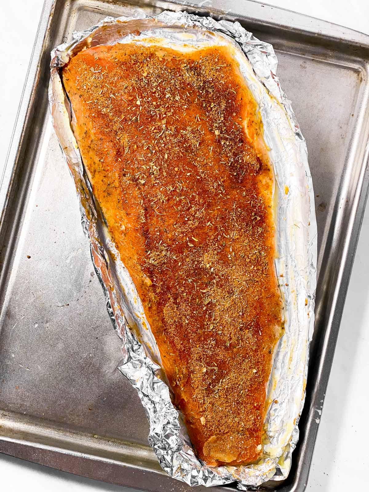 image of seasoned salmon fillet on baking sheet
