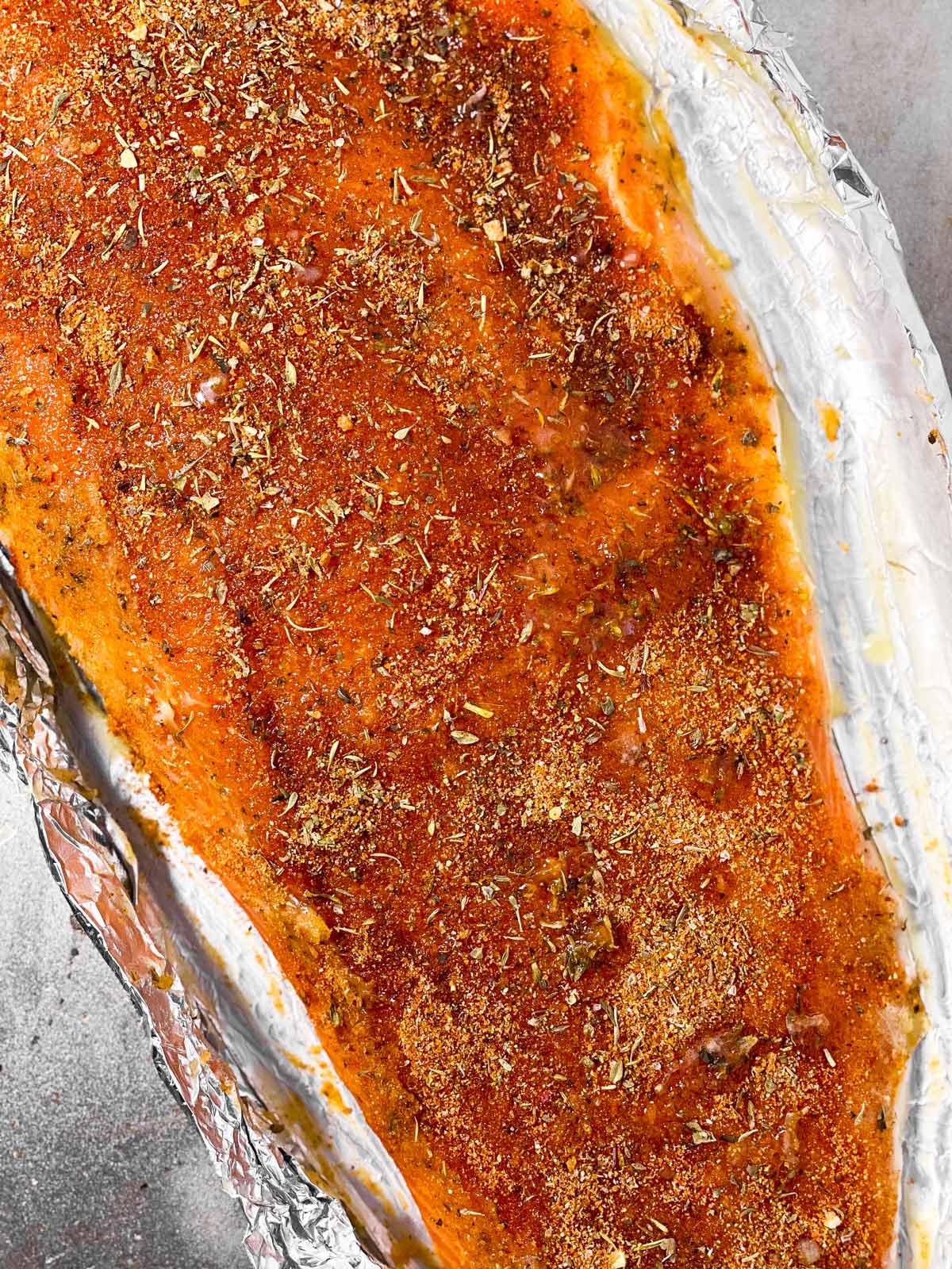 images of raw and baked salmon fillet on a baking sheet
