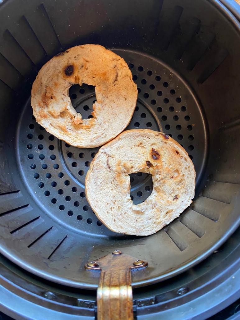 Two Halves of Bagel in an Air Fryer Basket