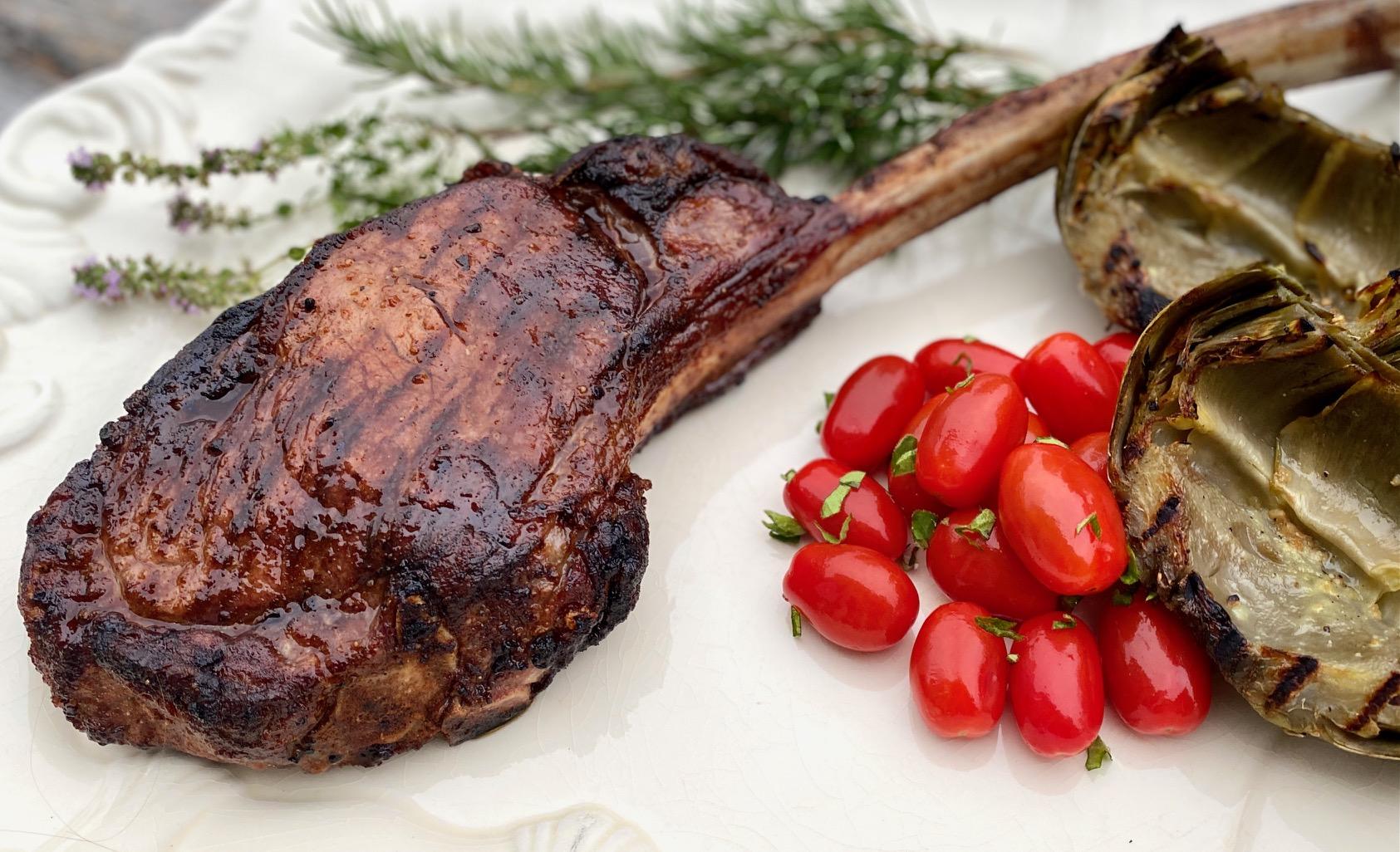 Grilled steak with rosemary and tomatoes