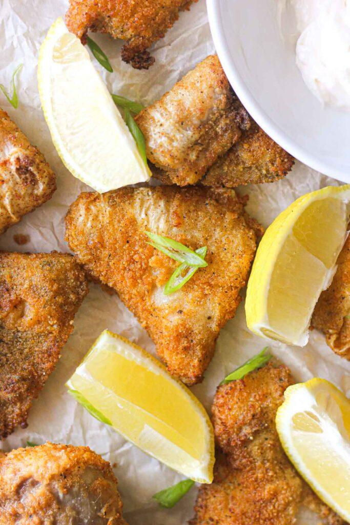 golden colored breaded catfish nuggets with lemon