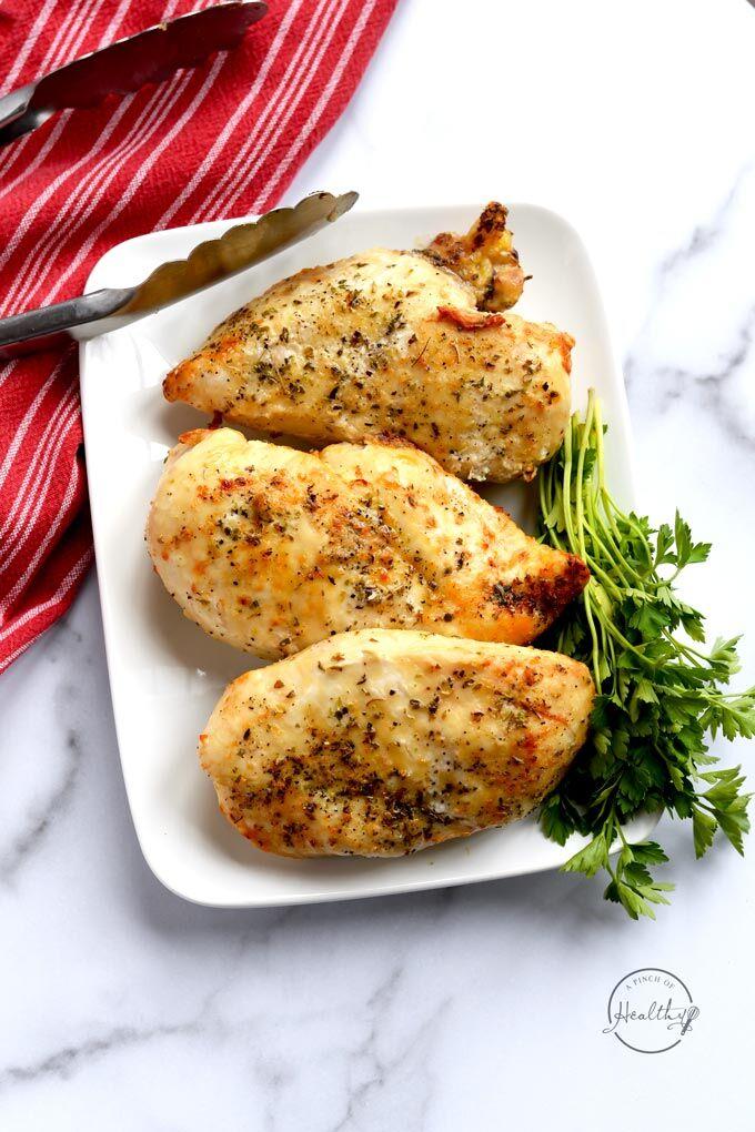 Air Fryer chicken breast shot overhead on marble counter with red towel