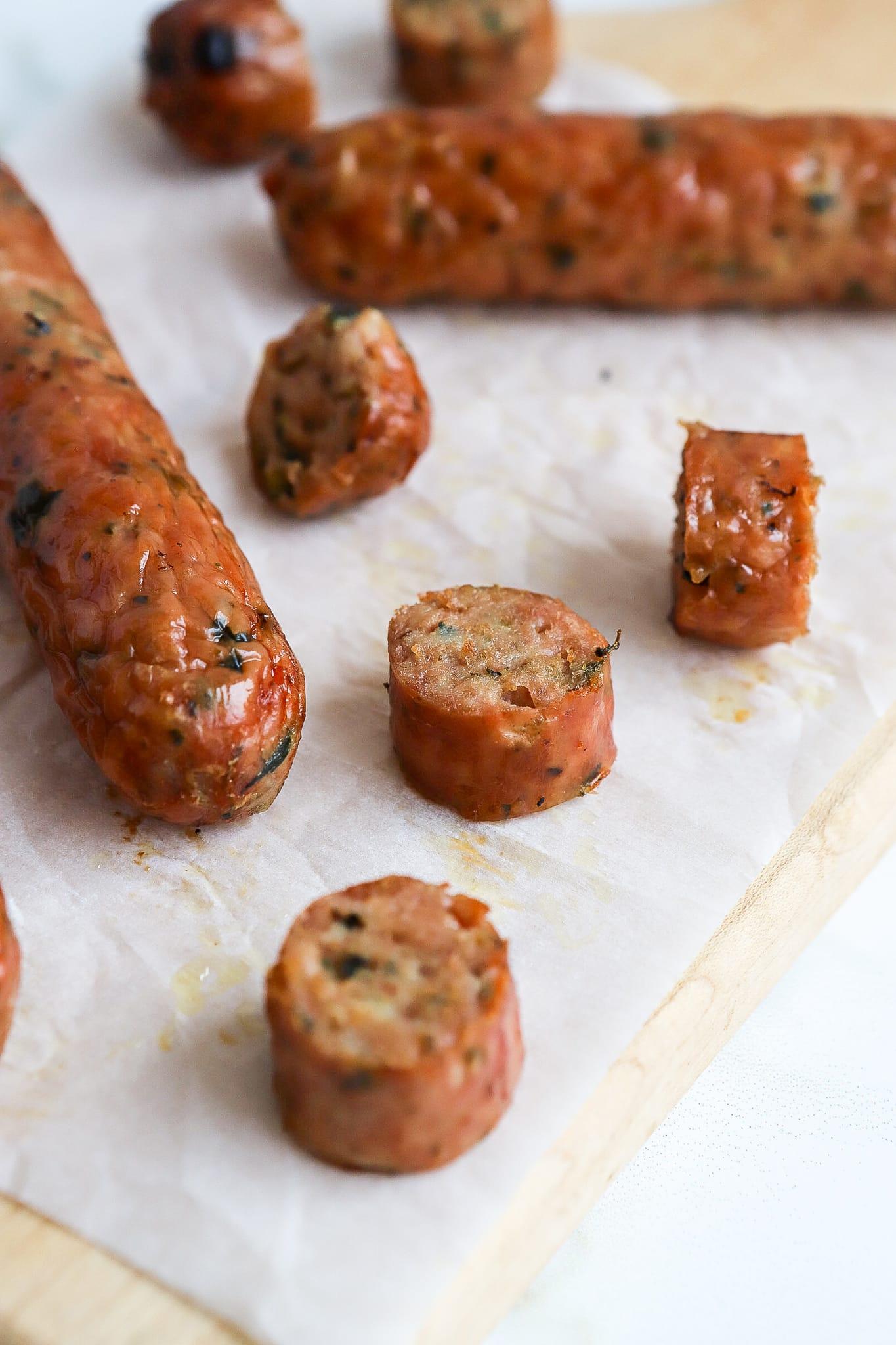 air fryer chicken sausage on a cutting board with parchment paper
