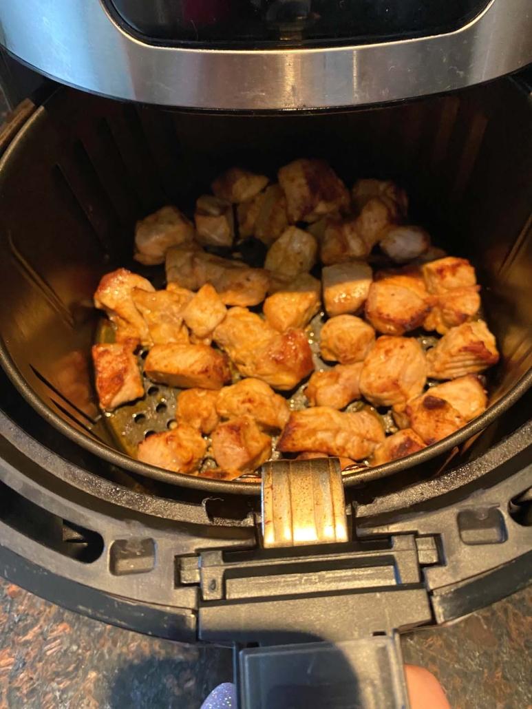 air fryer opened to show pork bites
