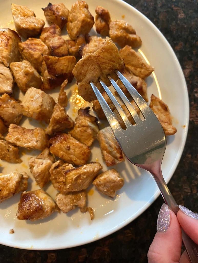 fork holding piece of easy Air Fryer Pork Bites